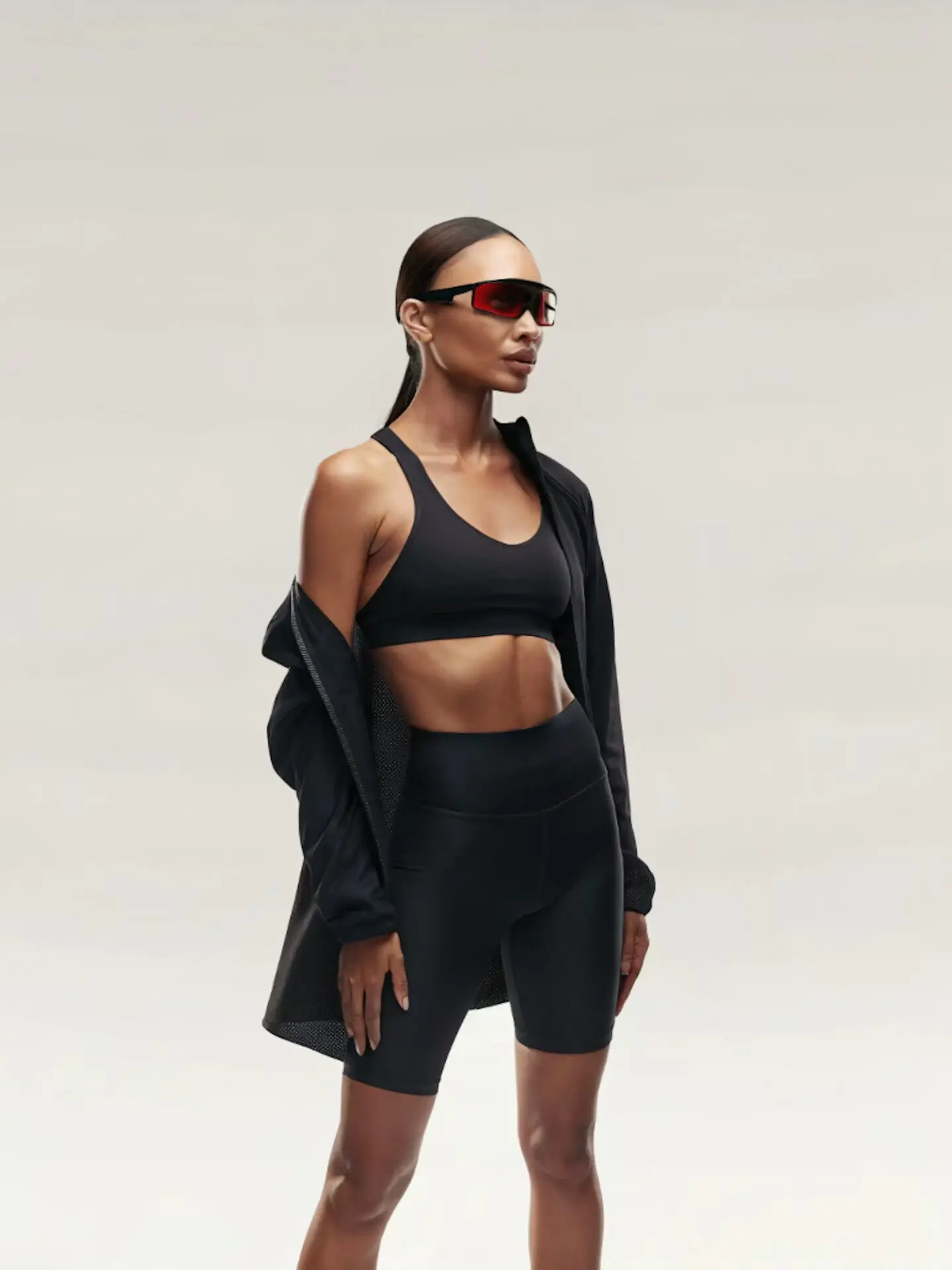 Woman in black athleisure wear and red sunglasses