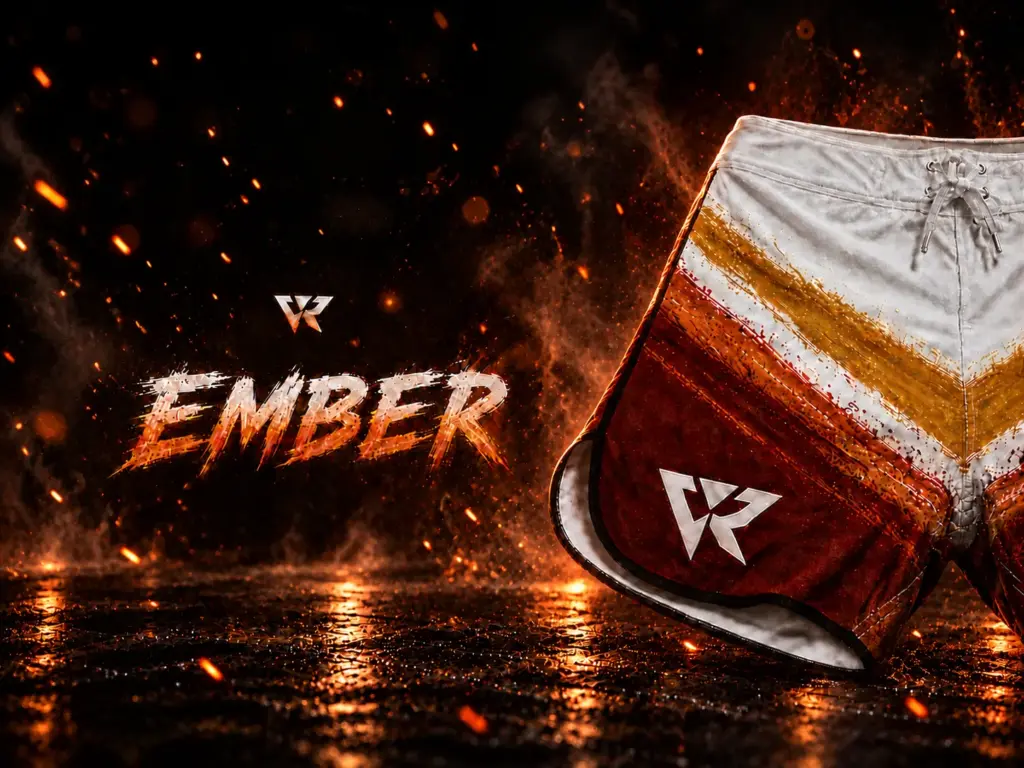 Close-up of the "Ember" line of athletic shorts with white and red-gold striped design, featuring the Veyrant logo, set against a fiery, smoky background with glowing embers.
