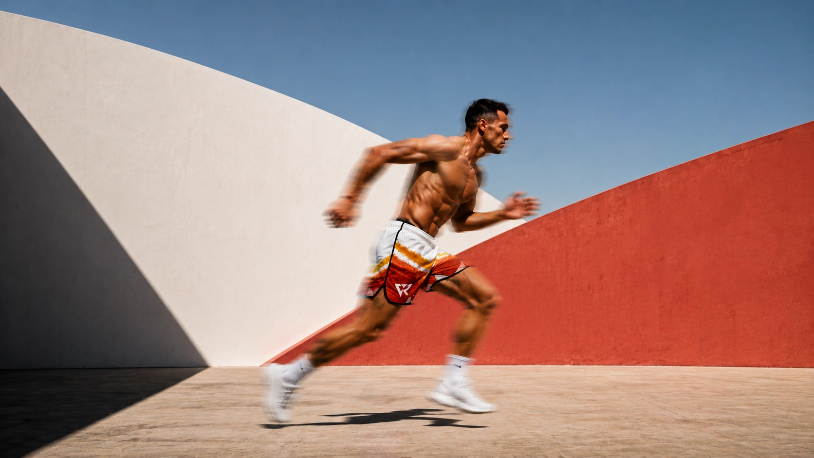 Fit man running with blurred motion against a red and white curved wall.