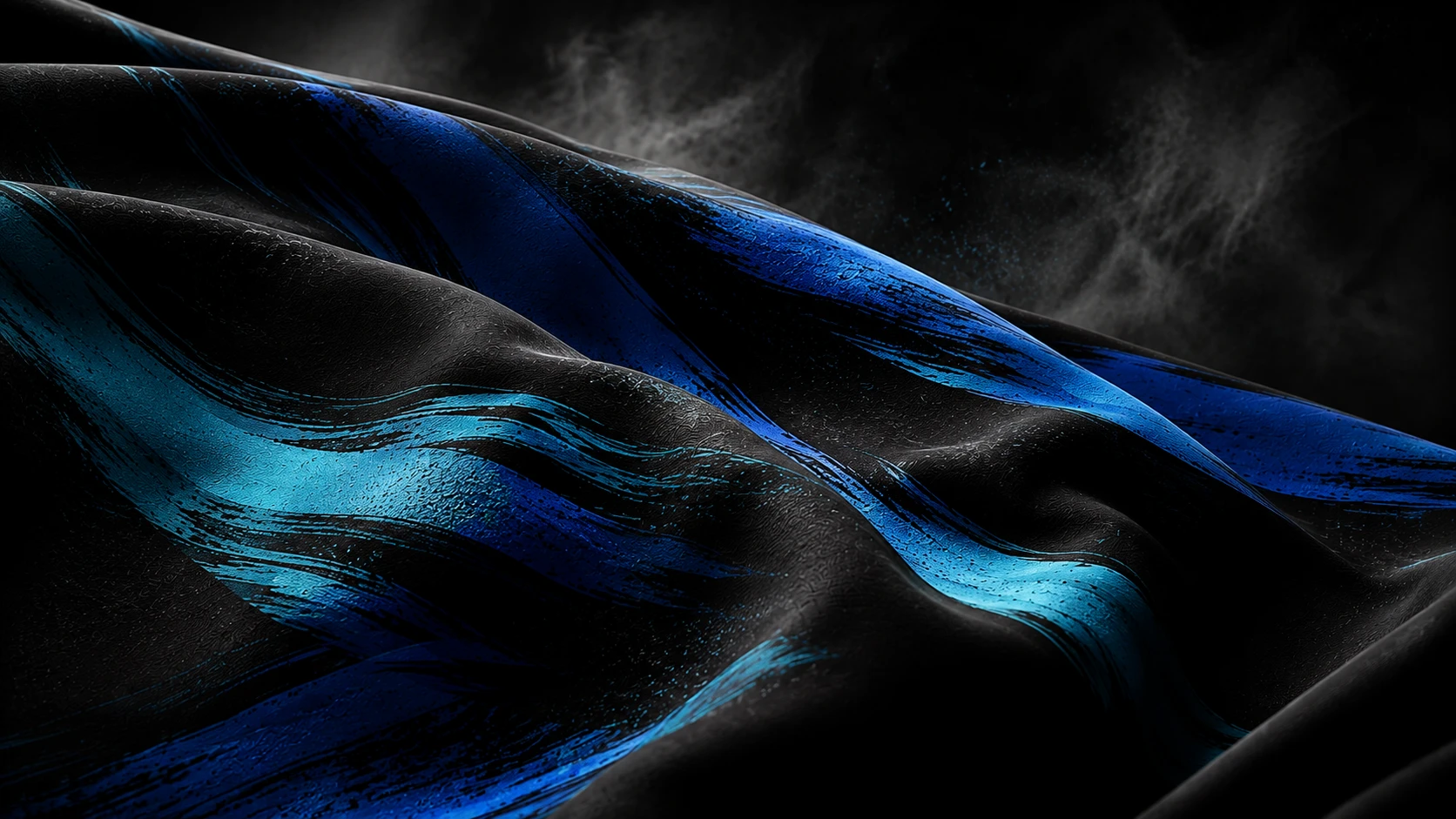 Close-up of a dark, textured fabric with bold, dynamic brushstrokes of vibrant blue and electric blue, creating a sense of movement and energy.